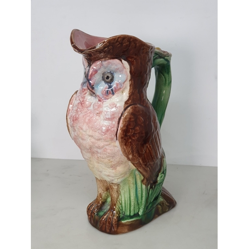 374 - A Majolica Jug in the form of an Owl with green branch and flower handle, A/F, 9.5