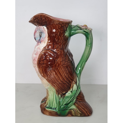 374 - A Majolica Jug in the form of an Owl with green branch and flower handle, A/F, 9.5