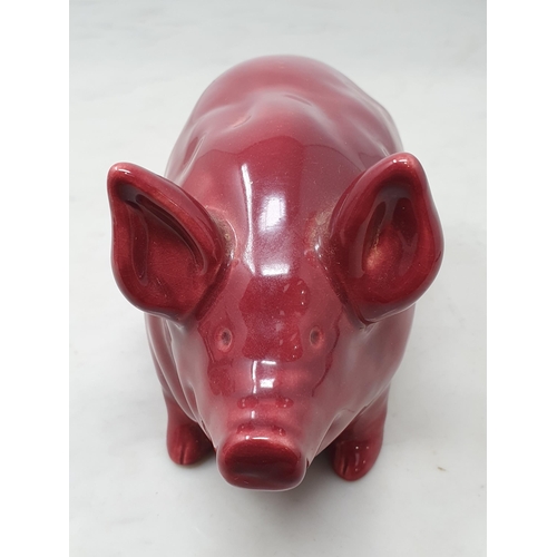 378 - A Seated Pottery Pig in Burgundy/Red glaze, 