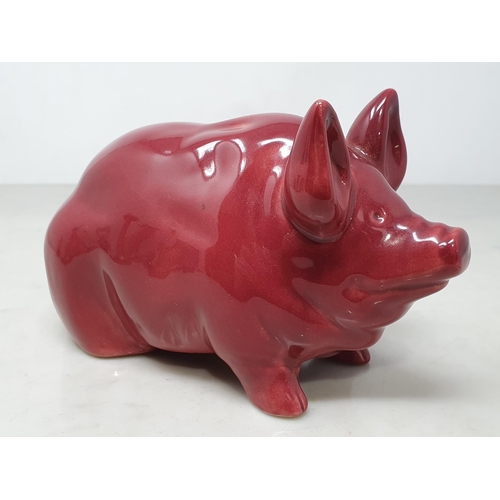 378 - A Seated Pottery Pig in Burgundy/Red glaze, 