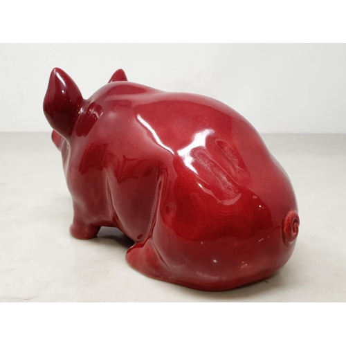 378 - A Seated Pottery Pig in Burgundy/Red glaze, 