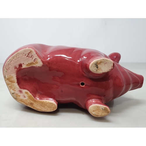 378 - A Seated Pottery Pig in Burgundy/Red glaze, 