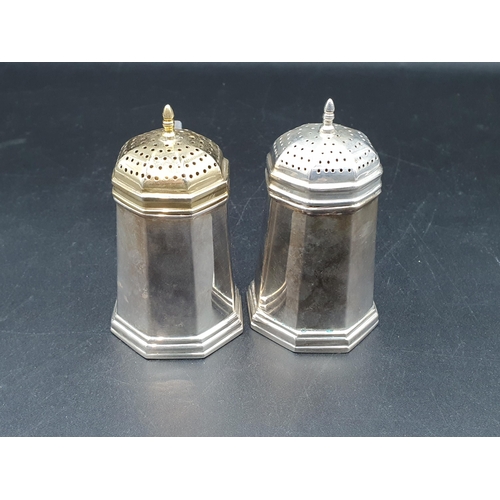 38 - A pair of modern Tiffany & Co, Sterling silver octagonal Pepperettes with scroll handles, one cover ... 