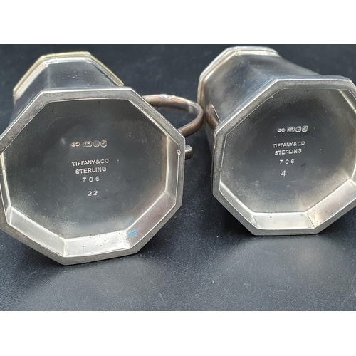 38 - A pair of modern Tiffany & Co, Sterling silver octagonal Pepperettes with scroll handles, one cover ... 