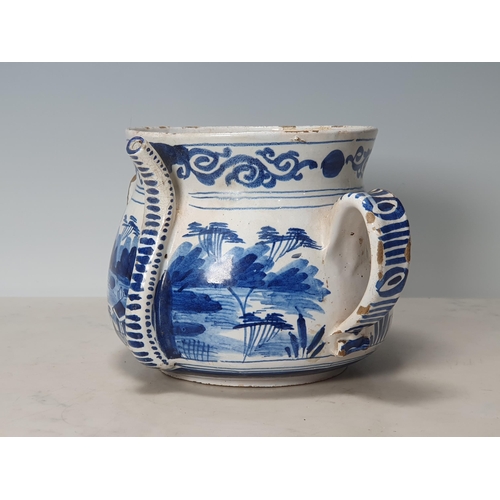 393 - A Delft blue and white two handled Posset Pot with scrolled frieze with Chinese Chinoiseries Landsca... 