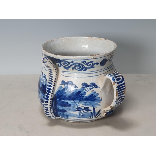 393 - A Delft blue and white two handled Posset Pot with scrolled frieze with Chinese Chinoiseries Landsca... 