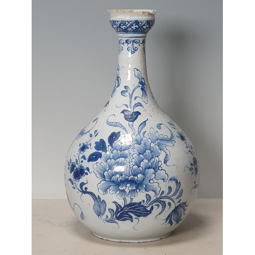 394 - A blue and white Delft Bottle Shaped Vase with all over Floral designs (Rim Chipped) 9.5