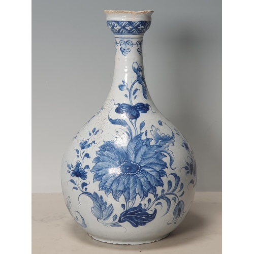 394 - A blue and white Delft Bottle Shaped Vase with all over Floral designs (Rim Chipped) 9.5