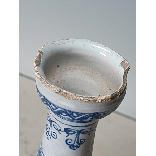 394 - A blue and white Delft Bottle Shaped Vase with all over Floral designs (Rim Chipped) 9.5