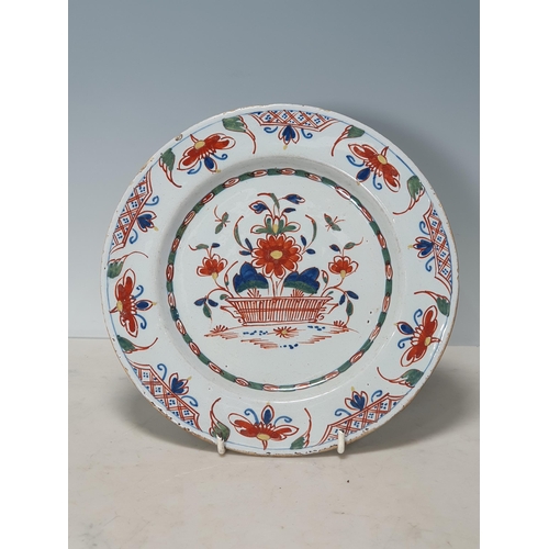 396 - Four Antique Delft Plates with polychrome decorations, one with Bird and Flowers, and three with Flo... 