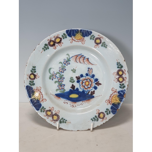 396 - Four Antique Delft Plates with polychrome decorations, one with Bird and Flowers, and three with Flo... 