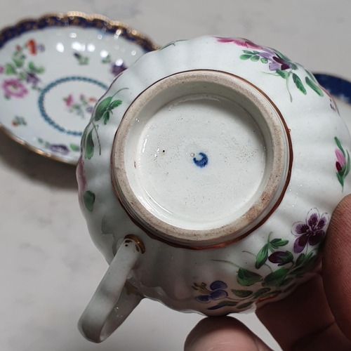 407 - A Worcester Cup and Saucer with moulded body, shaped rims, painted floral design, having blue border... 