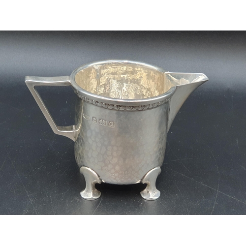 42 - A George VI heavy silver Milk Jug with leafage frieze and hammered design on four shaped feet, Birmi... 