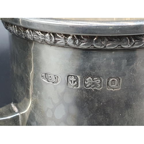 42 - A George VI heavy silver Milk Jug with leafage frieze and hammered design on four shaped feet, Birmi... 