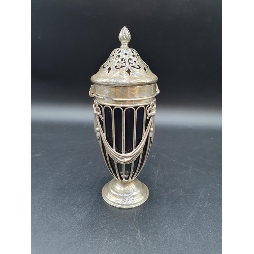 43 - An Edward VII silver Sugar Caster of urn shape decorated ribbons and swags, spiral finial, blue glas... 