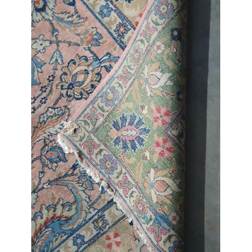 451 - A Persian Carpet with designs of flowers in colours to the border, the central ground decor stylised... 