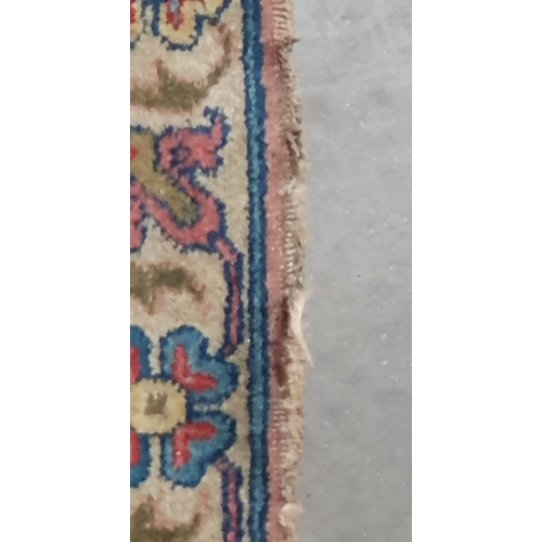 451 - A Persian Carpet with designs of flowers in colours to the border, the central ground decor stylised... 