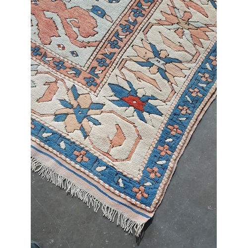 452 - A Turkish Carpet with floral designs to the multiple borders and central stepped medallion on a blue... 