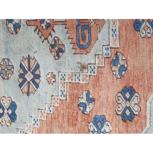 452 - A Turkish Carpet with floral designs to the multiple borders and central stepped medallion on a blue... 