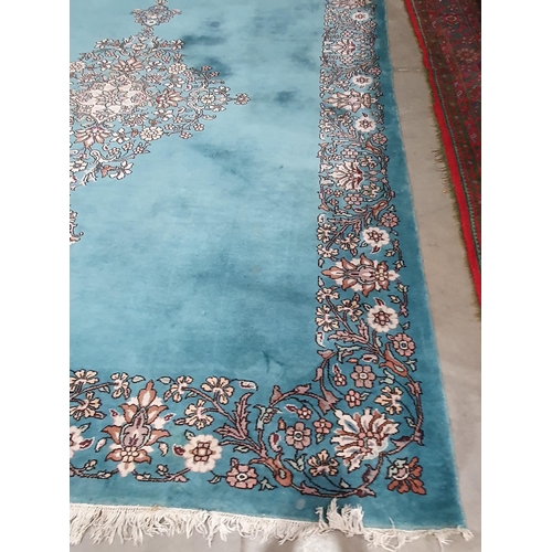 456 - A Chinese blue ground Carpet with central floral medallion and with floral scroll border in camel, r... 