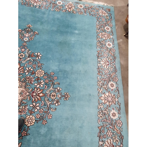 456 - A Chinese blue ground Carpet with central floral medallion and with floral scroll border in camel, r... 