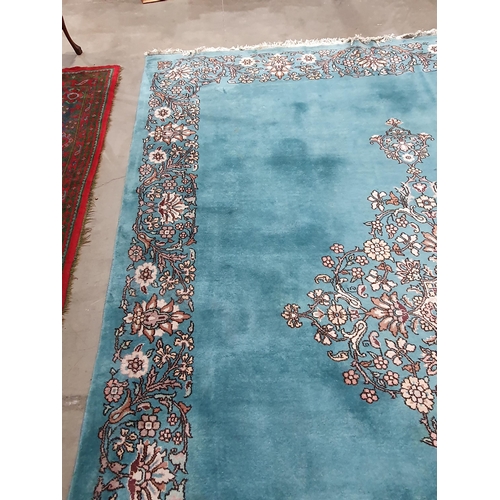 456 - A Chinese blue ground Carpet with central floral medallion and with floral scroll border in camel, r... 