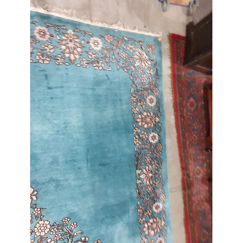 456 - A Chinese blue ground Carpet with central floral medallion and with floral scroll border in camel, r... 