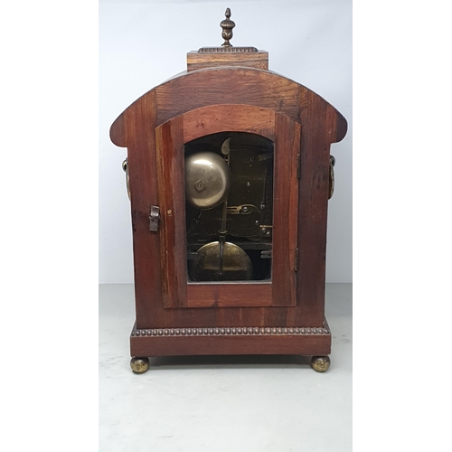 464 - A William IV rosewood Bracket Clock with circular enamel dial, brass Urn finial and ring handles rai... 