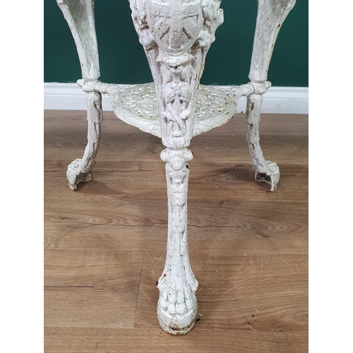 471 - A cast iron white painted circular Garden Table with pierced top, figural supports and paw supports,... 