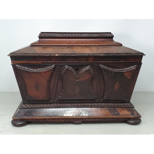 473 - A 19th Century rosewood and mahogany Sarcophagus Tea Caddy, with applied carved panels, pair of ring... 