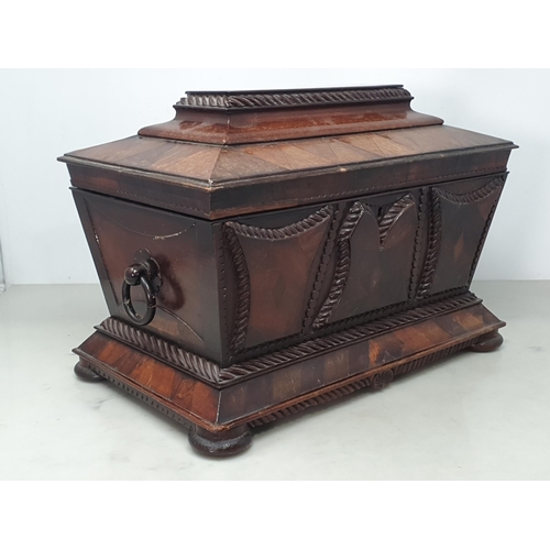 473 - A 19th Century rosewood and mahogany Sarcophagus Tea Caddy, with applied carved panels, pair of ring... 