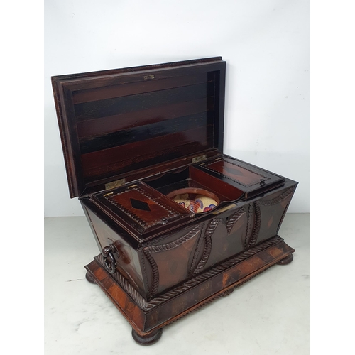 473 - A 19th Century rosewood and mahogany Sarcophagus Tea Caddy, with applied carved panels, pair of ring... 