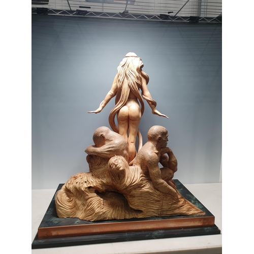 474 - Ian Norbury, a limewood and walnut carved female nude surrounded male figures on a rectangular base,... 