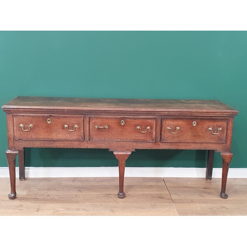 484 - An 18th century oak Dresser Base having cross-banded top above three cross-banded drawers on three c... 