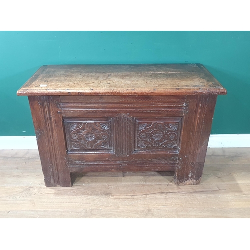 489 - An early 17th Century oak Coffer with later lid above carved two panel front and raised upon heavy g... 