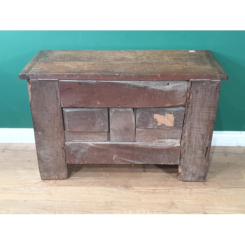 489 - An early 17th Century oak Coffer with later lid above carved two panel front and raised upon heavy g... 