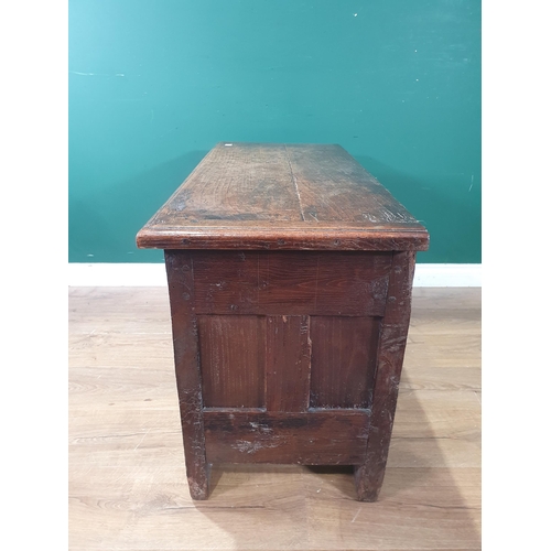 489 - An early 17th Century oak Coffer with later lid above carved two panel front and raised upon heavy g... 