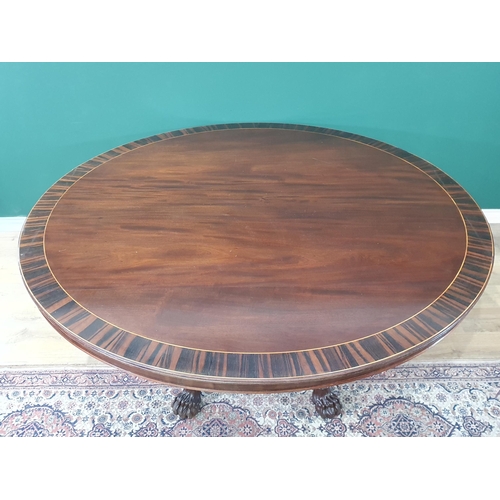 498 - A large Irish mahogany circular Dining Table with crossbanded top, raised on six spiral turned suppo... 