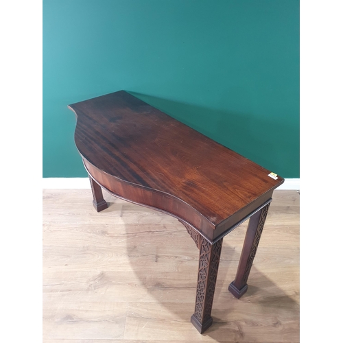 501 - An Irish mahogany Serpentine Serving Table raised on chamfered squared and blind fret carved support... 