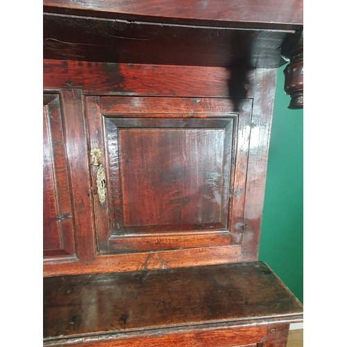 503 - An 18th C Oak Deuddarn the upper frieze carved IMI 1746 above a pair of cupboard doors, the base fit... 