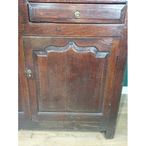 503 - An 18th C Oak Deuddarn the upper frieze carved IMI 1746 above a pair of cupboard doors, the base fit... 