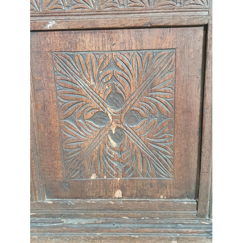 504 - A 17th C joined Oak Coffer with moulded two plank lid and clasp lock above quatrefoil leafage carved... 