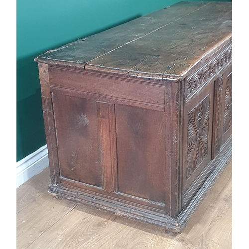 504 - A 17th C joined Oak Coffer with moulded two plank lid and clasp lock above quatrefoil leafage carved... 