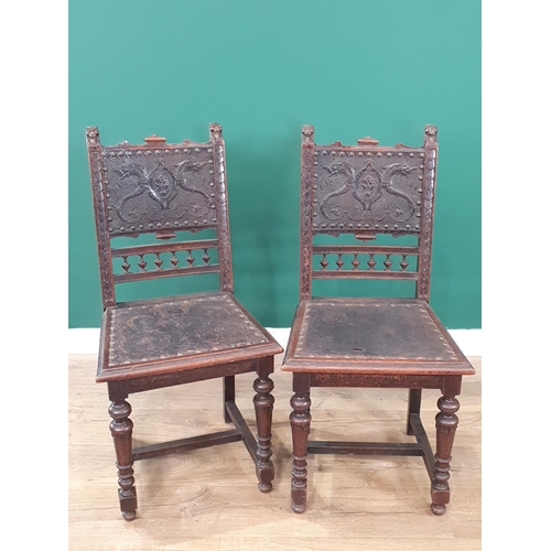 507 - A pair of 19th Century carved oak Hall Chairs with finely carved lion mask finials, tooled and embos... 