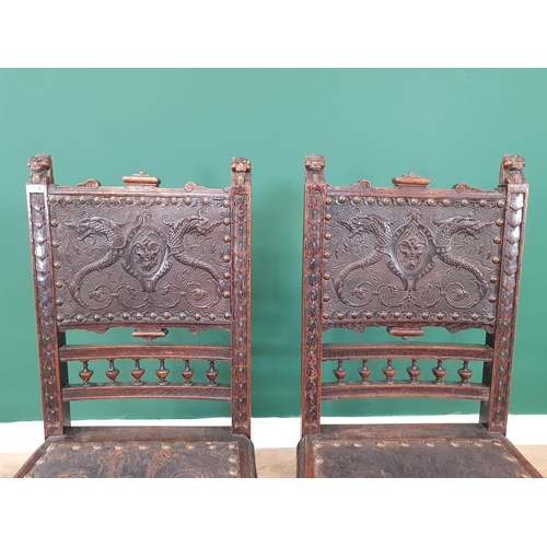 507 - A pair of 19th Century carved oak Hall Chairs with finely carved lion mask finials, tooled and embos... 