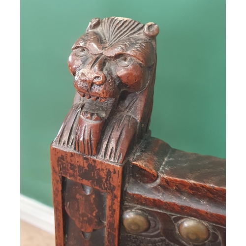 507 - A pair of 19th Century carved oak Hall Chairs with finely carved lion mask finials, tooled and embos... 