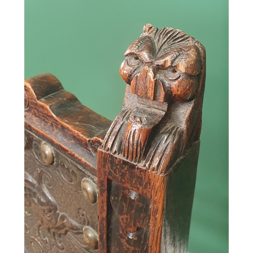 507 - A pair of 19th Century carved oak Hall Chairs with finely carved lion mask finials, tooled and embos... 