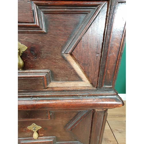 508 - A 17th Century oak Chest of two short and three long drawers with moulded top and geometric moulded ... 