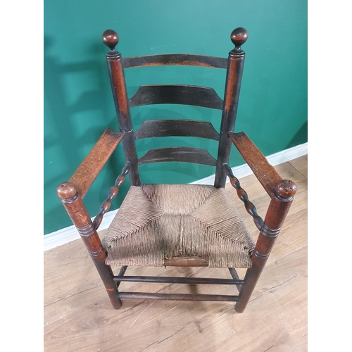 515 - An 18th Century primitive Elbow Chair with ladder back, rush seat on turned supports & stretchers.