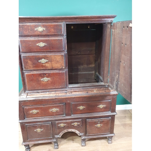 519 - An 18th Century oak Chest on Stand with an usual arrangement of four short drawers and a cupboard wi... 